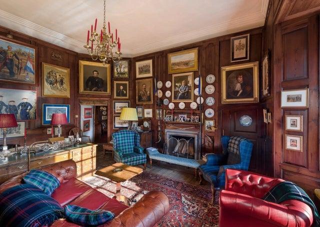 One of the eight reception rooms, this library room has a log fire.