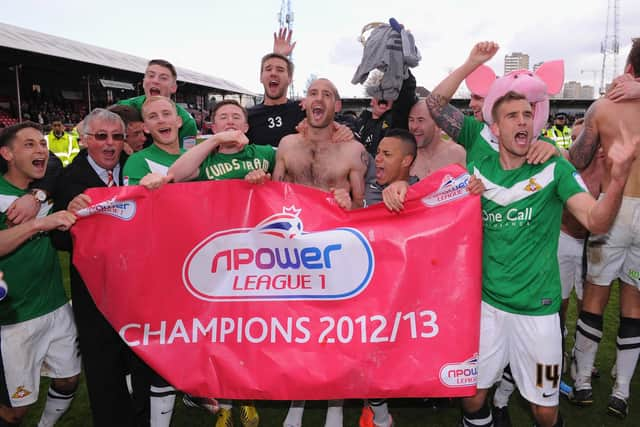 Doncaster Rovers' players celebrate winning the League One title at Griffin Park on April 27, 2013 (photo by Mike Hewitt/Getty Images).