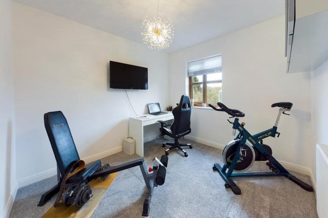 A versatile room doubling as an office and a home gym.