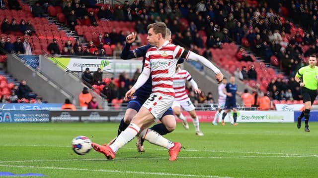 Doncaster's James Maxwell scores the opening goal.