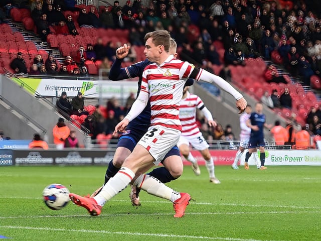 Doncaster's James Maxwell scores the opening goal.