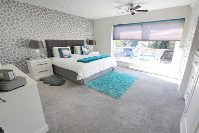 The master bedroom has carpeted flooring, LED spotlights, an extensive range of fitted wardrobes, electric heated flooring, electric blinds and double glazed sliding doors opening out on to the rear balcony.