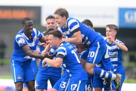 Ben Close is mobbed by his teammates after scoring the winning goal.