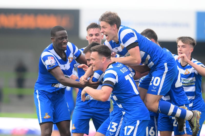 Ben Close is mobbed by his teammates after scoring the winning goal.