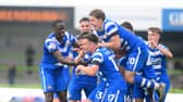 Ben Close is mobbed by his teammates after scoring the winning goal.