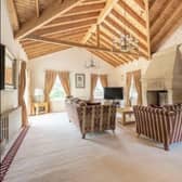 The lounge has large windows to let in an abundance of natural light, it is spacious and designed with a modern timber effect.
