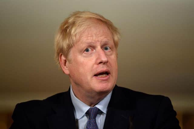 Boris Johnson said he was 'confident' families would be able to enjoy Christmas together- if people follow the rules (Photo by LEON NEAL/POOL/AFP via Getty Images)