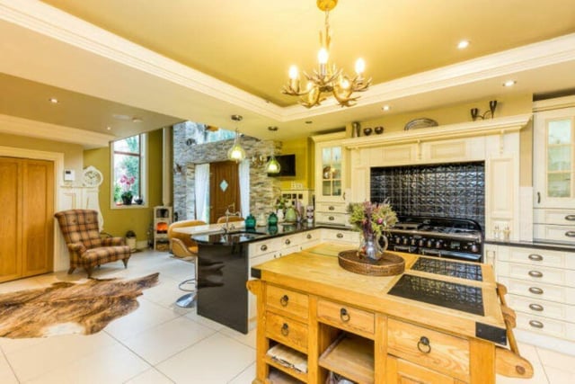 A spacious and well equipped open plan kitchen with central island.
