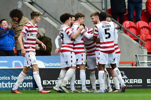 Doncaster's players celebrate George Miller's goal.