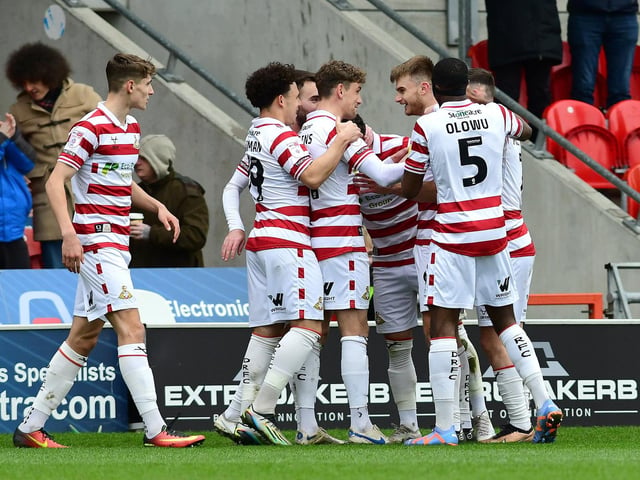 Doncaster's players celebrate George Miller's goal.