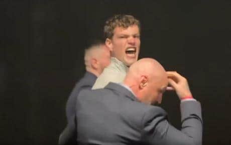 One protester was led away by security after heckling Mr Farage.