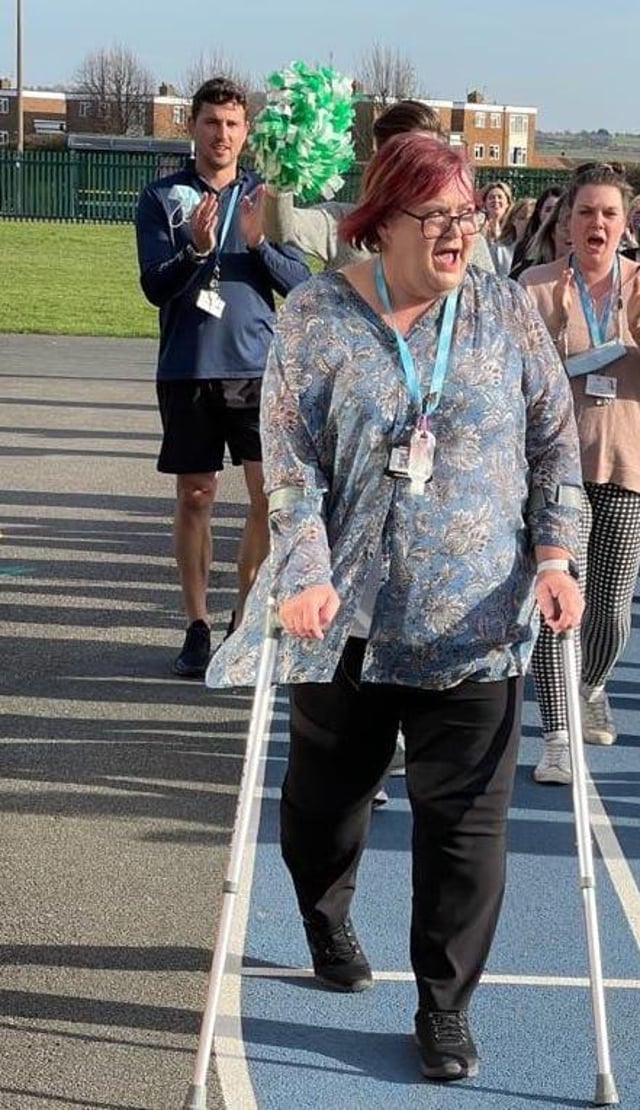 Gill Wright with her work colleagues completing her final mile