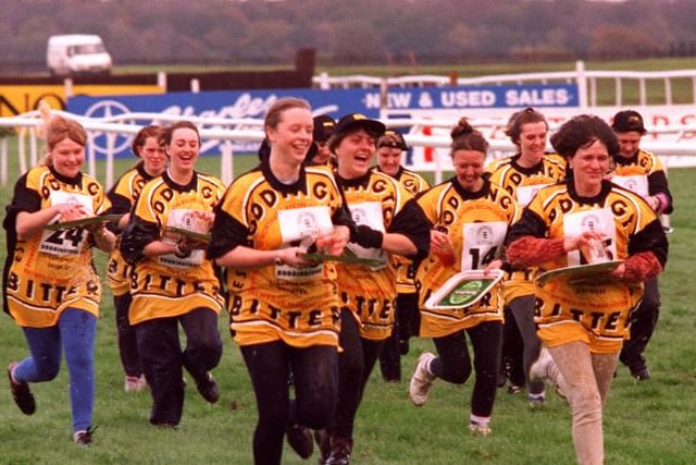 Doncaster Racecourse in 1996 - the Barmaids Derby team run towards the finish line.