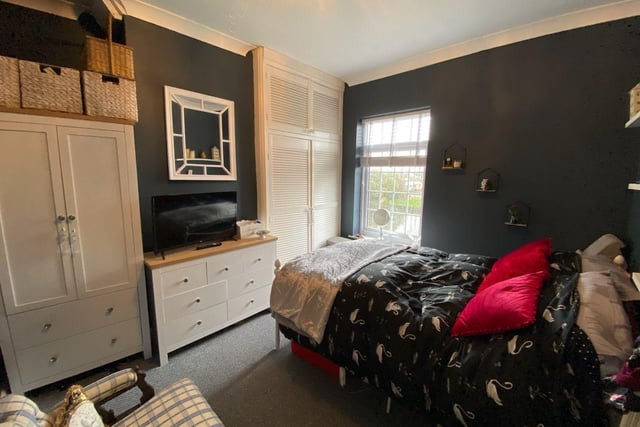 This is the double bedroom, which appears spacious and has built in storage.