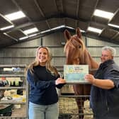 Mr Dunnett receiving his certificate on his farm