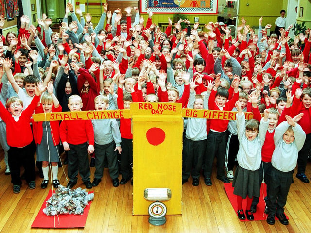 Conisbrough Station Road Primary School pupils celebrate their Comic Relief fund-raising efforts. Balancing the scales are, from left, Sophie Vukelic, aged four, Calvin Rodgers, aged five and Jack Wainwright, aged four. The total amount raised at the school was £404-10 in March 1997