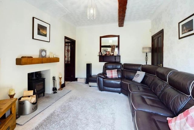 A cosy, beamed reception room within the character home.