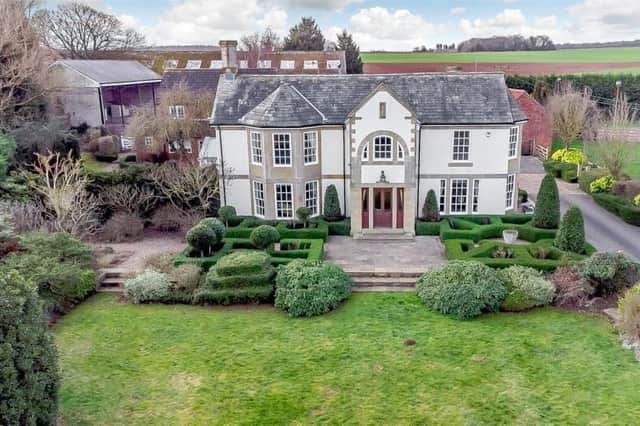 The six bedroom property sits on a five-acre plot, with landscaped gardens, tennis courts and an annexe converted from stables.