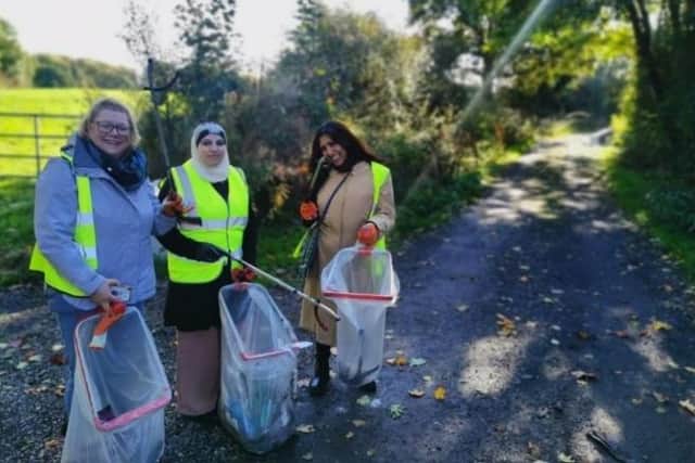 Participants and staff cleaning up near the Bentley Mill Dike.