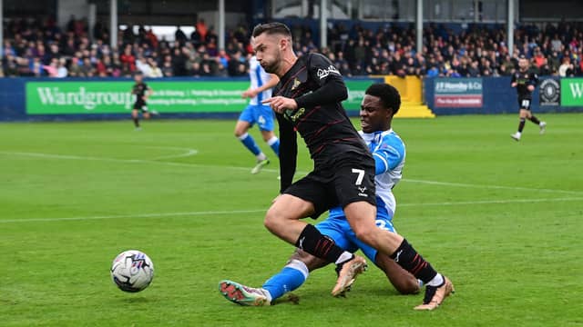 Doncaster Rovers' Luke Molyneux is fouled by Barrow's Tyrell Warren
