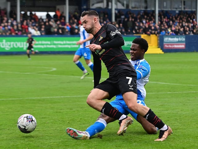 Doncaster Rovers' Luke Molyneux is fouled by Barrow's Tyrell Warren