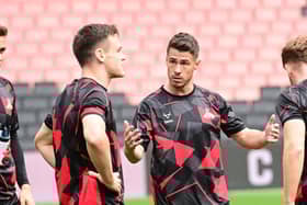 Tommy Rowe has joined Premier League giants Manchester United in a hybrid, player-coaching role with their under-21s side.