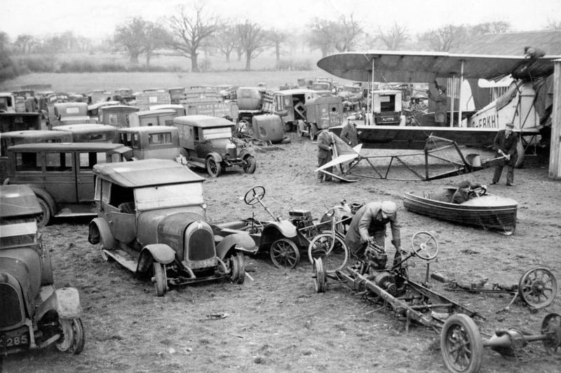 The backyard of a Yorkshire mechanic Reg Fowler, with his collection of aeroplanes, cars and so on, near Thorne, on 14th December 1933. He rebuilds the cars and aeroplanes, and the parts left over are sold for scrap.