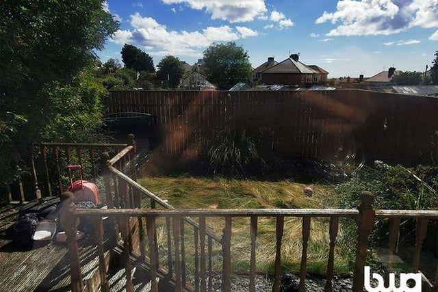 Although pictured slightly overgrown, this ample sized back garden comes with a nice wooden decking feature taking you down to ground level.