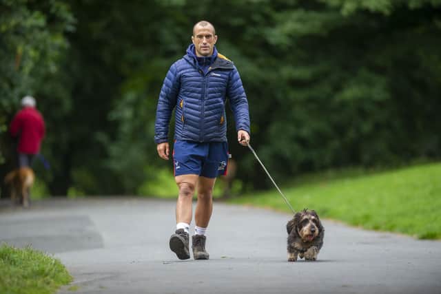 Steve Boden walking his dog in Roundhay Park in Leeds. Picture Tony Johnson