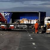 Workmen continuing on the site of the four vehicle crash which closed the M180 near Thorne, Doncaster, last night, and has remained closed on one carriageway today