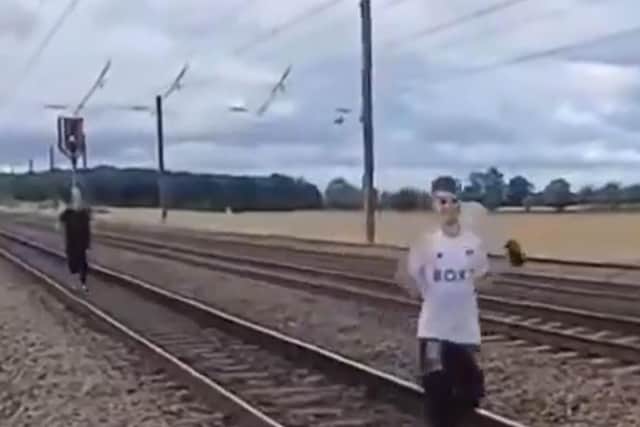 Two men were filmed running along the East Coast Main Line. (Photo: X).