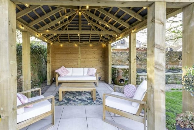 The pergola provides covered seating space.