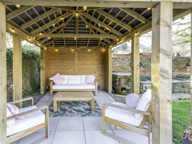 The pergola provides covered seating space.