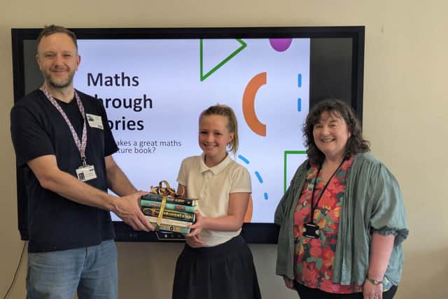 Charlotte being presented with her prize by local author Phil Sheppard and Anne Walker from RWM Doncaster.