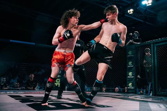 Leo Palmer in red shorts in kickboxing victory