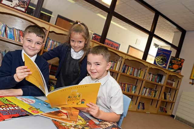 James Susek, Kadie Priestley and Callum Pearman, all seven, pictured in the school library. Picture: NDFP-12-11-19-DenabyMainPrimary-1