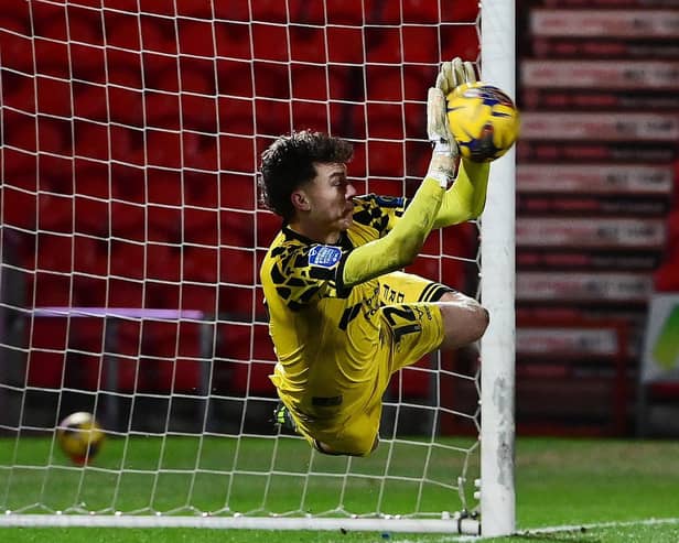 Louis Jones saves the penalty to put Rovers into the next round. Picture: Howard Roe/AHPIX.com