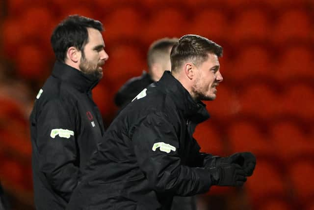 Danny Schofield (left) watches on with his assistant Chad Gribble.