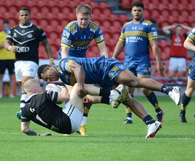 Jason Tali tackles Nathan Hill. Photo: Rob Terrace