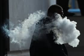 The vapor cloud produced by a man with an e-cigarette