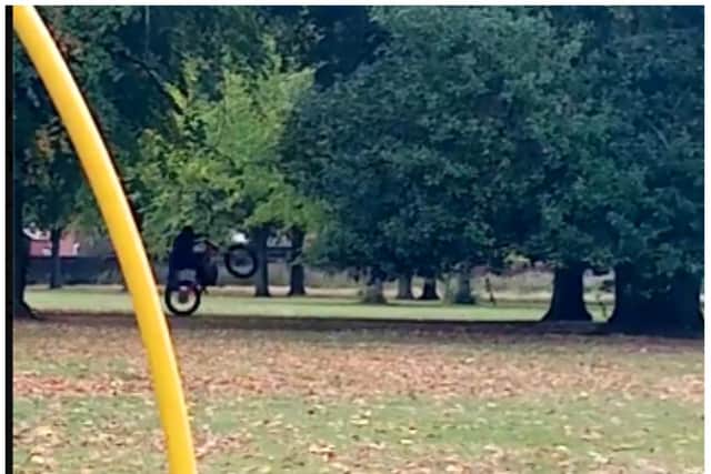 An off road biker was filmed pulling a wheelie just yards from where children were playing in Elmfield Park.