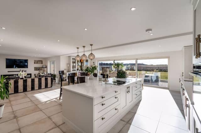 The property has a fabulous living kitchen, with both dining and family areas having doors to outside.