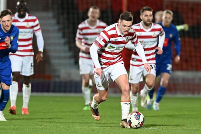 Luke Molyneux drives forward with the ball.