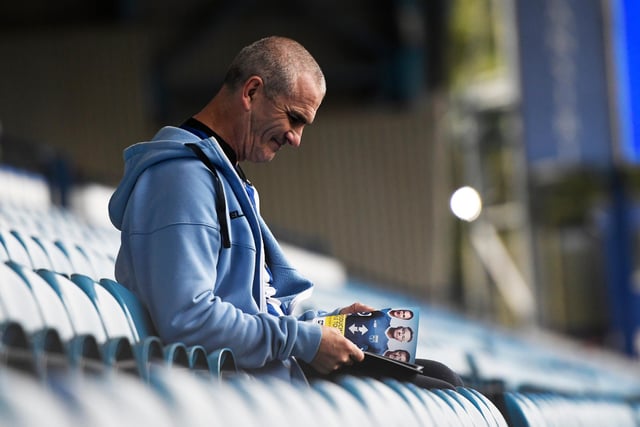 A Wednesday fan reads the programme prior to the Sky Bet Championship match against Luton Town at Hillsborough in August 2019.