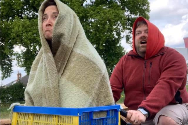 Damien and Lydia Oliver stunting up ET in their garden with a crate and a couple of hoodies