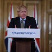 British Prime Minister Boris Johnson gestures as he gives a press conference about the ongoing situation with the coronavirus (COVID-19) outbreak inside 10 Downing Street on March 18, 2020 in London, England. (Photo by Eddie Mulholland - WPA Pool/Getty Images)