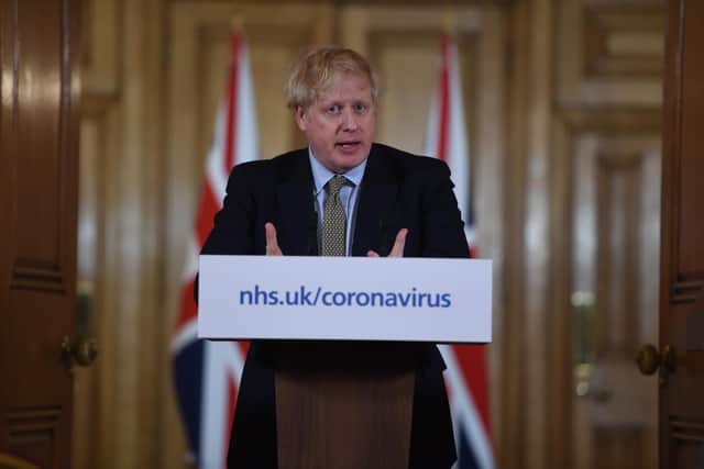British Prime Minister Boris Johnson gestures as he gives a press conference about the ongoing situation with the coronavirus (COVID-19) outbreak inside 10 Downing Street on March 18, 2020 in London, England. (Photo by Eddie Mulholland - WPA Pool/Getty Images)