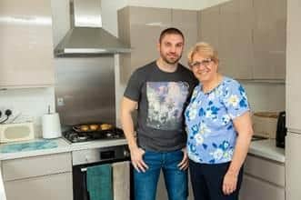 Barbara and her son Andrew in the kitchen of their new home