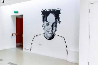 The art brings murals that would usually be outside into the gallery.