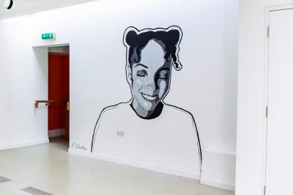 The art brings murals that would usually be outside into the gallery.